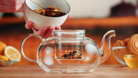 preparing loose leaf tea in a glass teapot