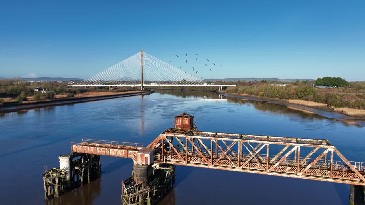 Ireland Epic Locations birds flying over old railway bridge ruin with modern bridge Thomas Francis Meagher Bridge Waterford in autumn