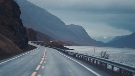 the narrow two-lane road runs along the fjord