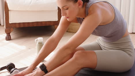 woman stretching on yoga mat at home, focusing on flexibility and wellness