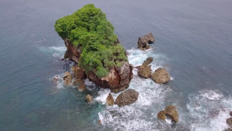 top view of waves breaking on rocks