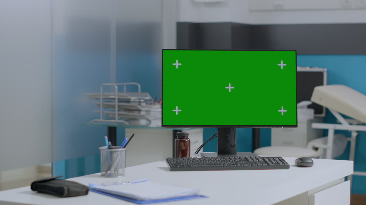 Office setup with green screen monitor