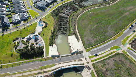 Arial-video-of-Melbourne-Western-suburbs-on-a-nice-day-from-DJI-Drone-showing-large-open-spaces-houses-water-ways-playground-from-the-air-bike-paths-Werribee-location-in-Melbourne-West