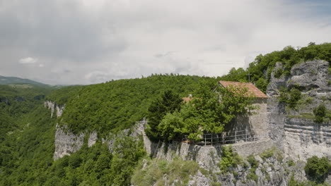 orthodox katskhi monastery on top of tall rock pillar cliff in georgia