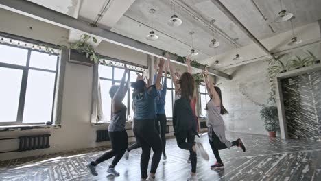 energetic women doing aerobics in circle