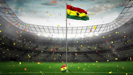 Animation-of-colourful-confetti-falling-over-flag-of-ghana-on-the-pitch-at-a-sports-stadium