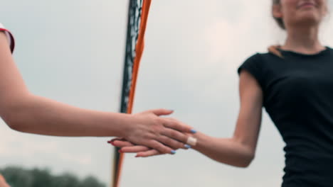 close-up greeting the hands of girls volleyball players thanking the opponent for the last match in slow motion