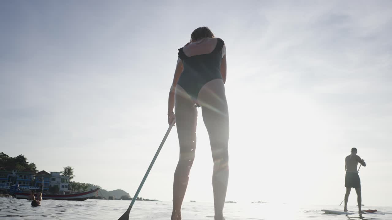 People Paddleboarding on a Sunny Day