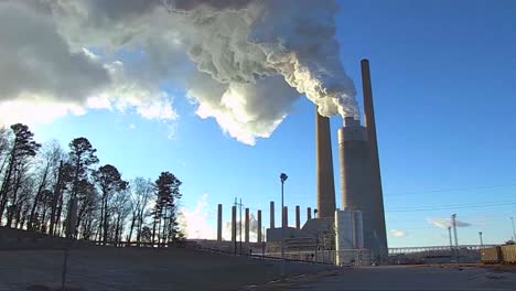 a coal fired power plant belches smoke into the air