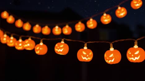 a festive display of glowing halloween pumpkin decorations strung across an outdoor space, illuminating the night with a spooky glow perfect for celebrations