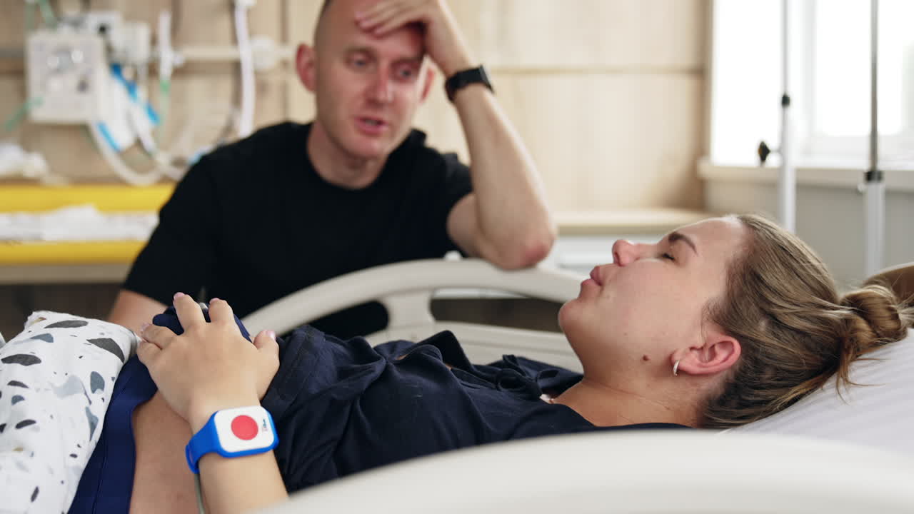 Woman in labor, supported by her husband in the hospital