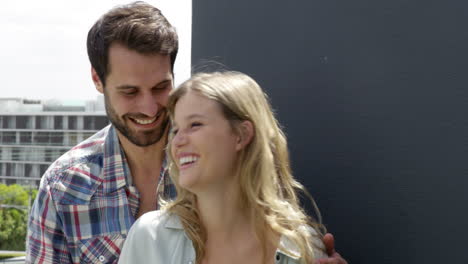 cute couple laughing on the balcony