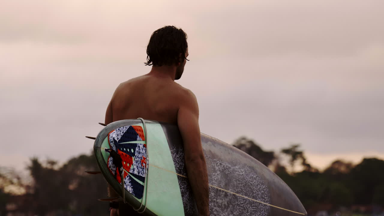 Surfer with surfboard at the beach