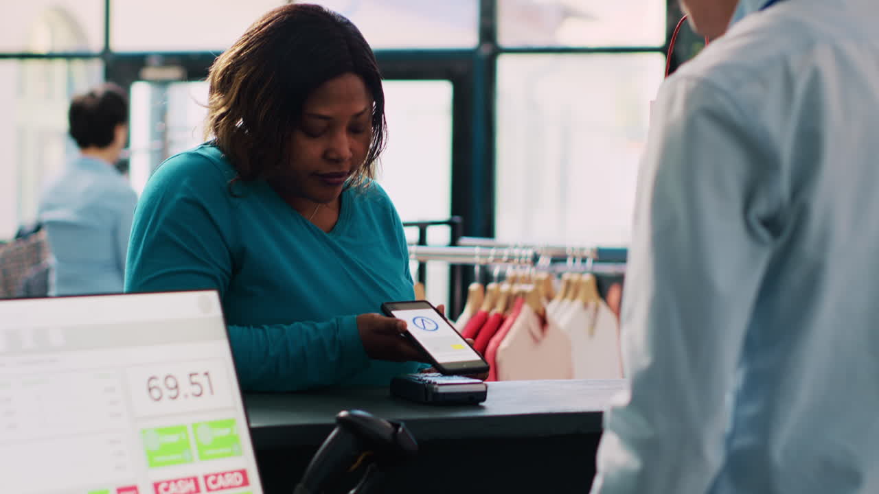 Client paying for casual wear with phone