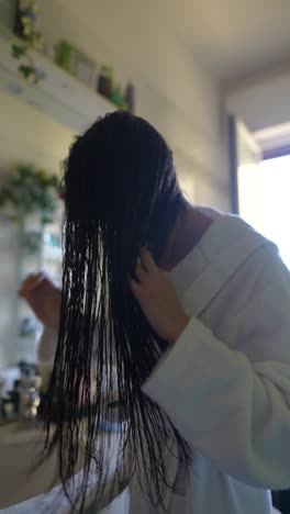 woman washing her long braided hair in the bathroom