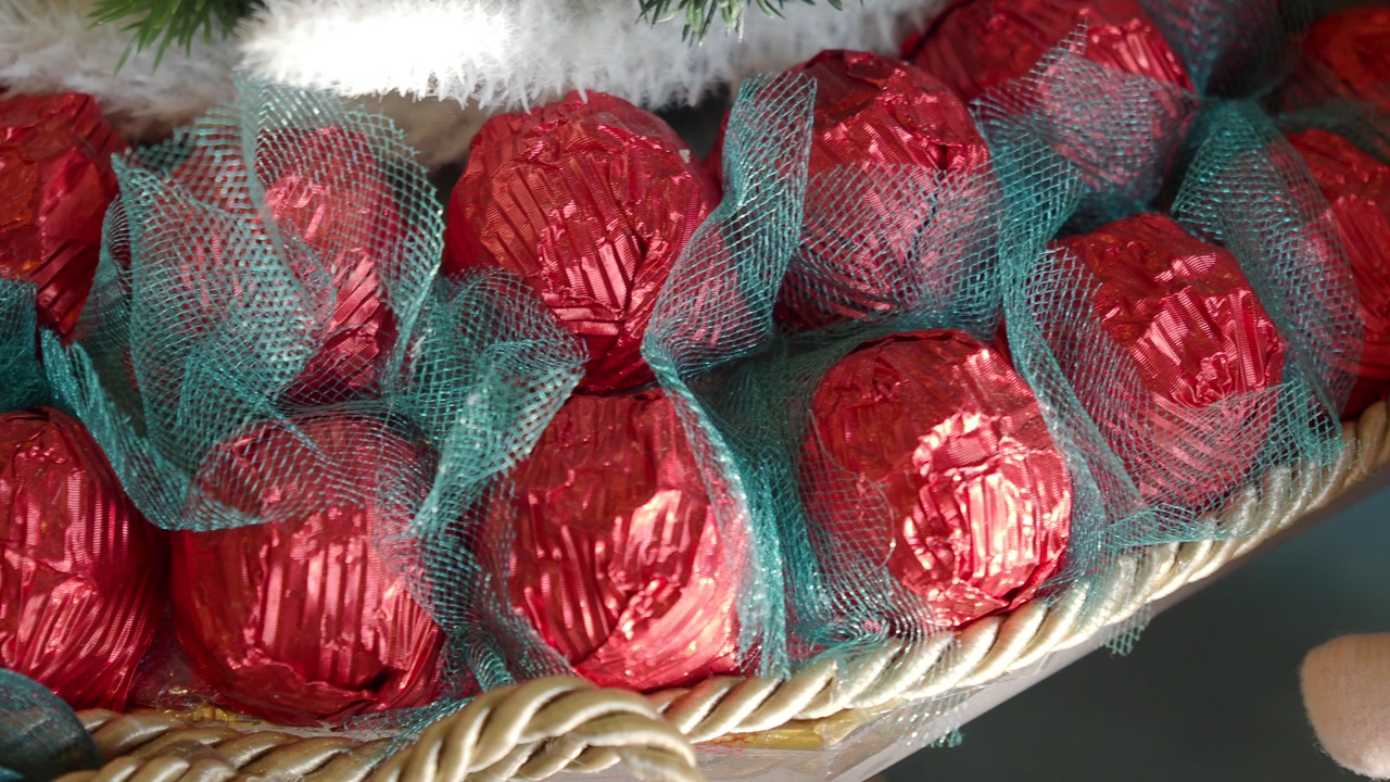 Red Foil Chocolates Wrapped in Green Mesh for Christmas