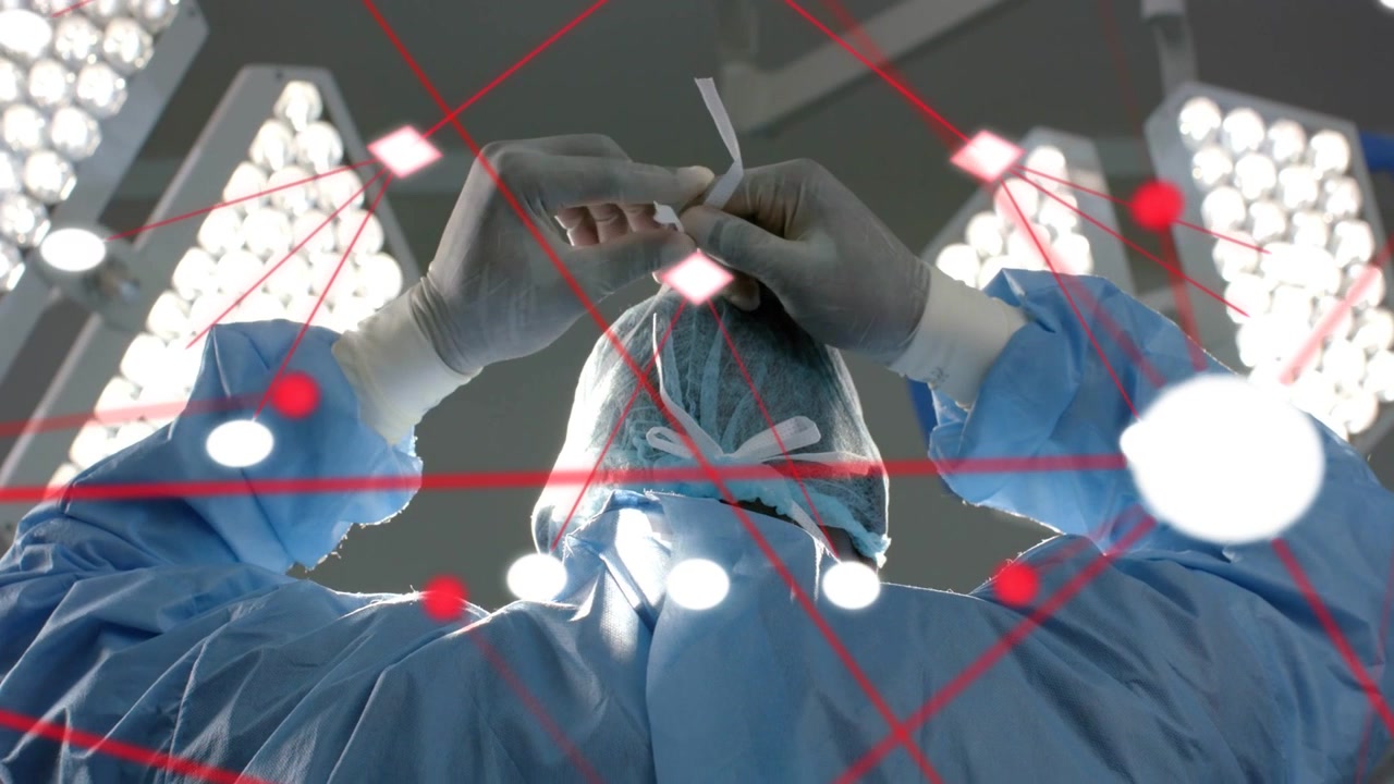 Video verticale: Chirurgo che lega i lacci della cuffia e della maschera preparandosi per la procedura, con nodi animati che mappano l'adattamento.