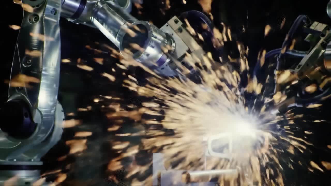 Advanced Robotic Arms Engaging in Precision Welding with High-Intensity Sparks and Seamless Automation for Effective Manufacturing Processes