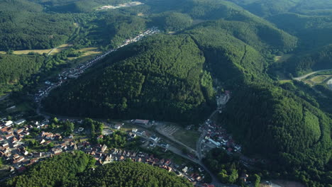 aerial view of a german valley town nestled amongst hills and forests