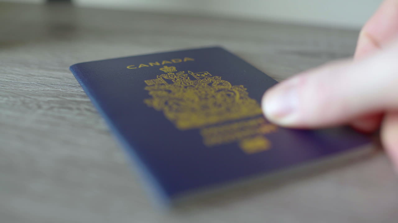 Close up of a passport being handed over to an agent on a table