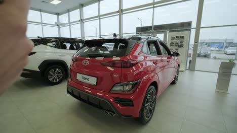 hyundai car dealership. the dealership manager takes pictures of a new car for sale. an overview of the new prestigious cars in the showroom.