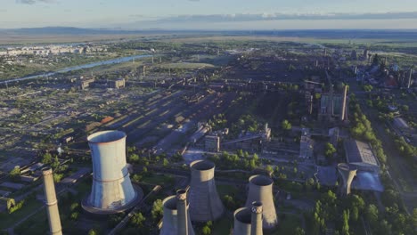 tilt-up reveal shot of large cooling towers at the galati eco metal recycling plant in romania