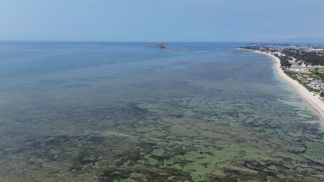 Stunning aerial drone footage of My Hoa Lagoon featuring a scenic lighthouse and tranquil waters in Vietnam, surrounded by lush nature and shallow water