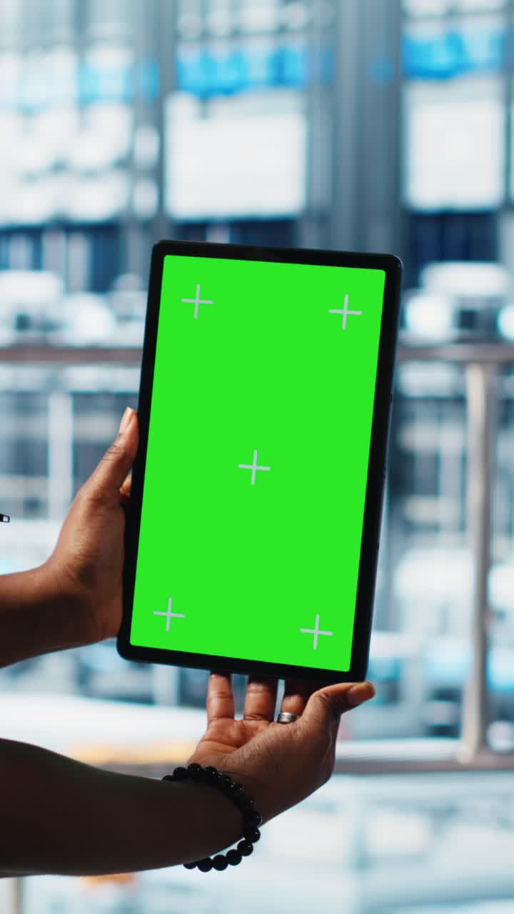 Vertical video Robotics technician using chroma key device in smart factory