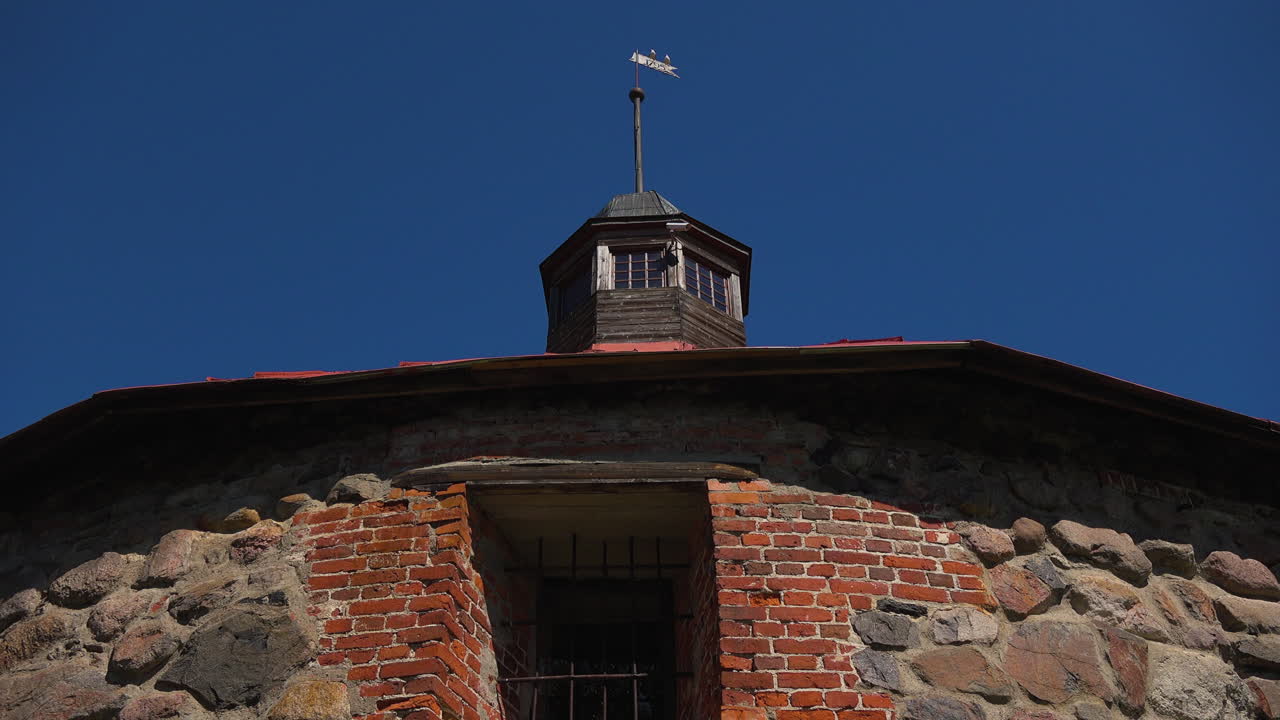 An outdoor panning view of sky and fortress tower with the fabulous stone wall. Russia