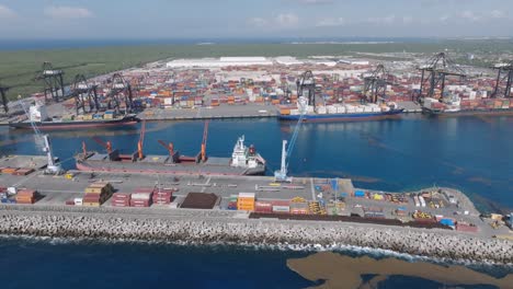 aerial view of multimodal caucedo port with industrial cranes and container for cargo operation - boca chica, dominican republic