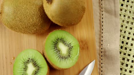 kiwi and knife on chopping board