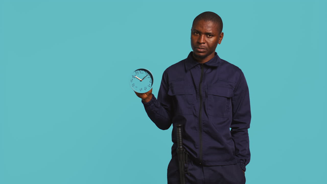 Security guard holding clock, rushing people out of property