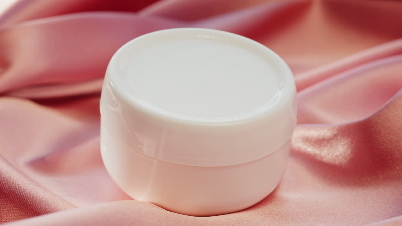 Beauty product on pink silk