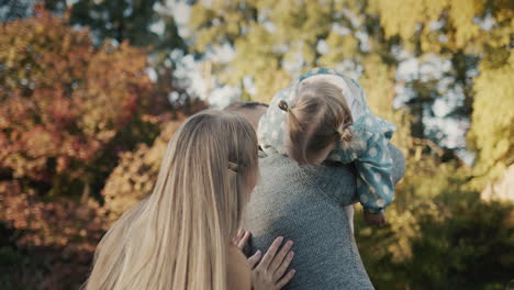 Happy-couple-playing-with-their-little-daughter-in-the-park.-Having-a-good-time-together