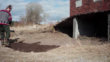 blending garden soil and organic fertilizer using rake