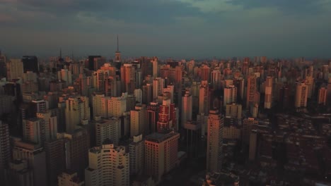 Beautiful-sunset-in-center-of-Sao-Paolo,-Brazil,-aerial-shot-pink-sky-and-buildings