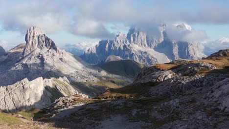 mountain landscape aerial reveal, monte pelmo mountain peak covered in clouds with alpine valley below, dolomites