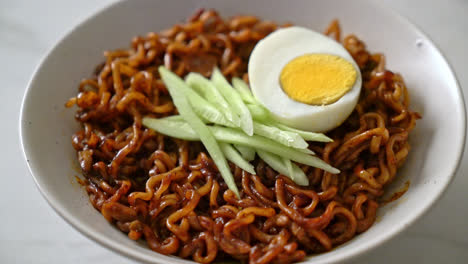 korean instant noodle with black bean sauce topped cucumber and boiled egg - korean food style