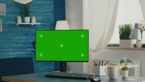 desktop computer with mock-up green screen chroma key placed on desk