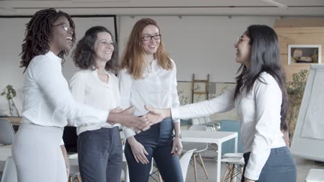 multiethnic businesswomen shaking hands