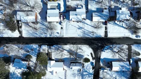 birds eye view of snow covering home roofs