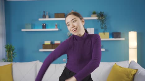 happy asian woman dancing at home.