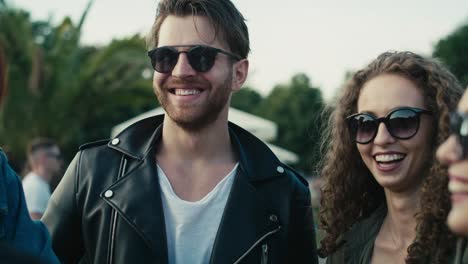 Group-of-young-caucasian-friends-chatting-and--having-fun-on-music-festival