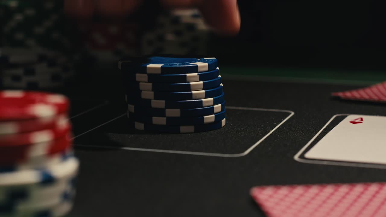 Hands managing poker chips on green table, reflecting intense poker gameplay with the element of chance and skill