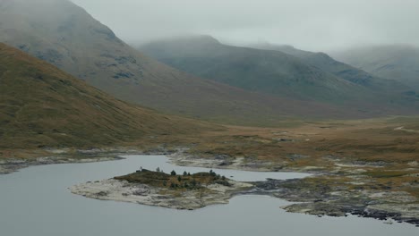 circling right shot of loch cluanie and towering highlands shrouded in mist