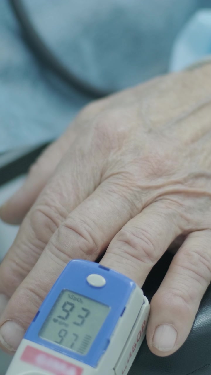 Senior Patient Wearing Pulse Oximeter on Finger in Hospital