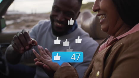 couple exchanging ring inside car, showing floating thumbs-up icons and social media bubble