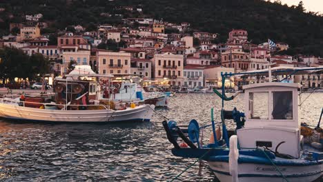 Fishing boats Portside in Greek harbour waterfront evening sunset golden hour