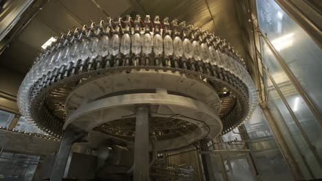 automatic filling machine pours water into plastic pet bottles at modern beverage plant