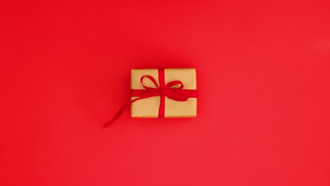 red romantic valentine's day gift box with red ribbon changing quickly on red background - stop motion